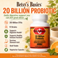 Betsy's Basics 20 Billion Probiotic supplement bottle shown on a warm beige promotional background with text callouts, icons, and food imagery including orange slices, mint, and a cup of tea.