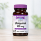 A bottle of Bluebonnet Ubiquinol 100 mg dietary supplement, featuring an amber glass bottle and a purple cap, set against a soft-focus background.