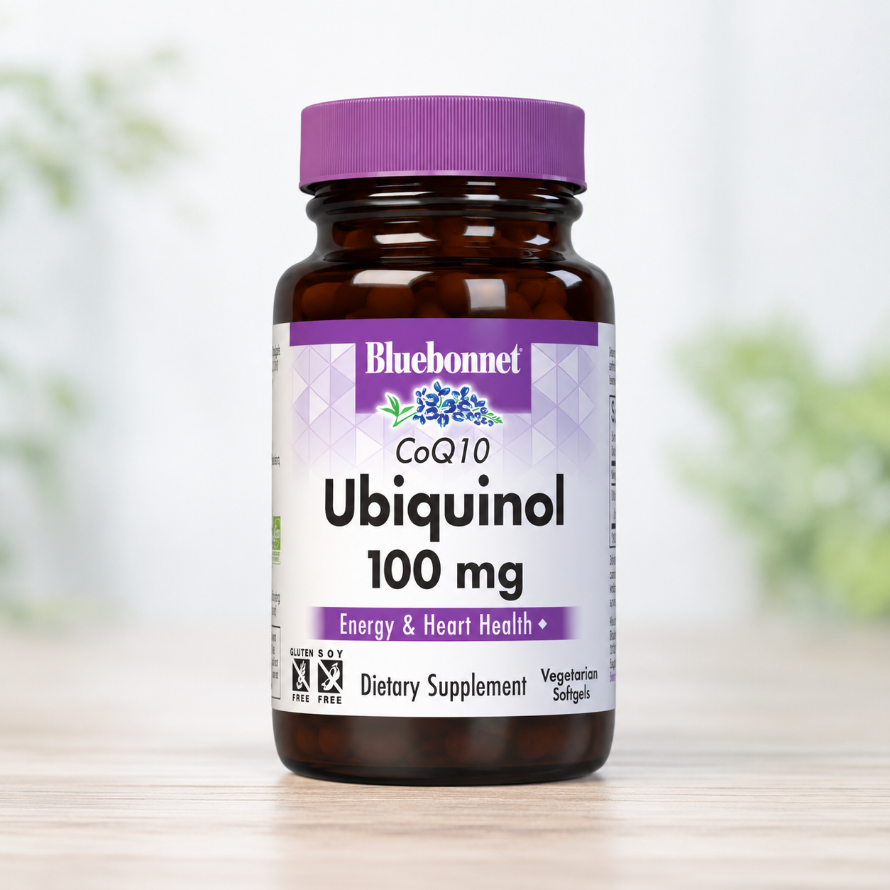 A bottle of Bluebonnet Ubiquinol 100 mg dietary supplement, featuring an amber glass bottle and a purple cap, set against a soft-focus background.