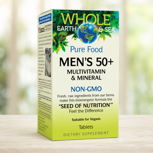 A box of Whole Earth & Sea Men's 50+ Pure Food Multivitamin & Mineral tablets, shown standing upright on a light wooden surface with a softly blurred green and white background.