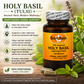 A bottle of Holy Basil (Tulsi) liquid veggie caps by Betsy's Basics, displayed on a wooden surface with fresh herbs and capsules. The left side features a text panel detailing the benefits of Holy Basil, and the right side shows the amber bottle with its orange label.
