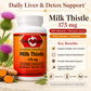 A bottle of Betsy's Basics Milk Thistle 175 mg dietary supplement capsules, shown alongside milk thistle flowers, turmeric root, and ginger slices on a light beige background with product information text.