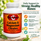 Supplement bottle of Betsy's Basics Calcium and Magnesium Citrates on top of a stone with greenery and a light background. Includes key selling points.