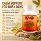 A bottle of Betsy's Basics Ashwagandha Extract 500 mg dietary supplement capsules, set on a rustic wooden background with leaves and ginger roots. The image includes marketing text highlighting its benefits for busy days and stress reduction.