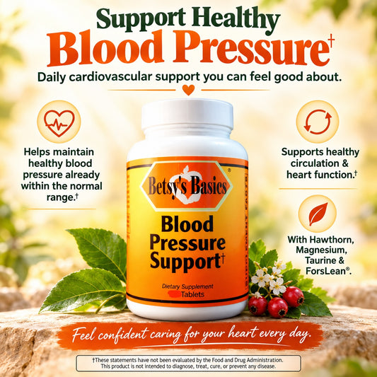 A bottle of Betsy's Basies Blood Pressure Support dietary supplement tablets centered on a wooden surface with a blurred outdoor garden background. The ad includes callout icons and text about supporting healthy blood pressure, circulation, and heart function.