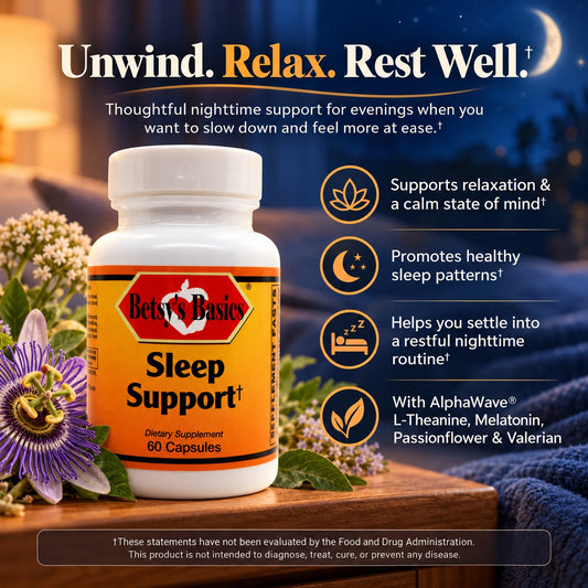 Bets' Basics Sleep Support dietary supplement bottle shown on a wooden surface with flowers, a cozy blanket, and a night sky background. The image includes marketing text and icons about relaxation, sleep patterns, and a restful routine.