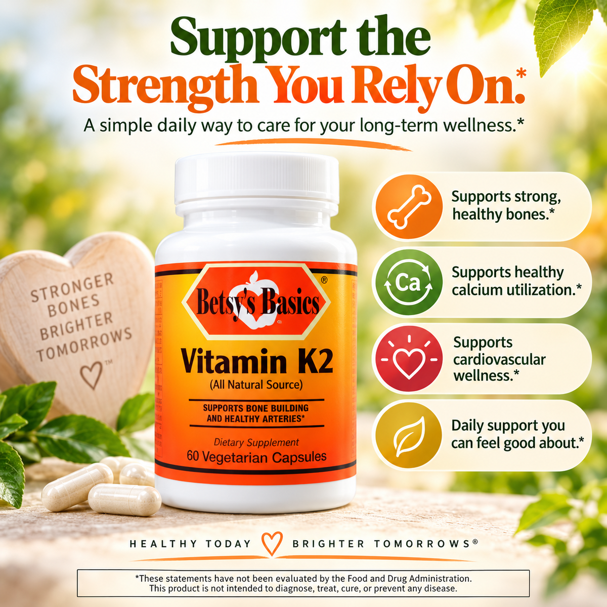 Betsy's Basics Vitamin K2 dietary supplement bottle on a bright, sunny outdoor-style background with green leaves and beige stones. The bottle is white with an orange label.