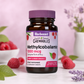 A bottle of Bluebonnet Earth Sweet Chewables Methylcobalamin 1000 mcg dietary supplement, Raspberry flavor, set against a soft pink background with fresh raspberries, green leaves, and lavender sprigs.