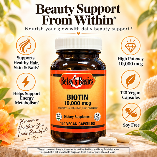 Betsy's Basics Biotin 10,000 mcg dietary supplement bottle with an orange label and white cap, surrounded by decorative text callouts and botanical elements on a warm beige background.