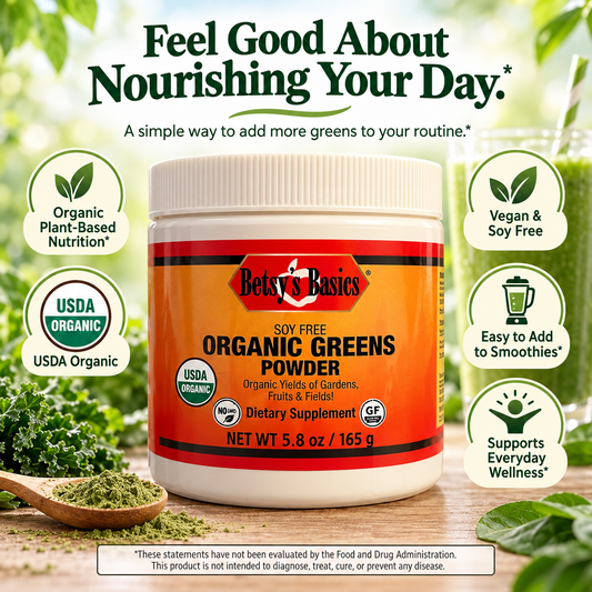 A jar of Betsy's Basics Organic Greens Powder dietary supplement centered on a wooden surface, surrounded by marketing callouts and fresh greens. The product label is orange and white with red accents, and the background is a soft-focus green outdoor scene.