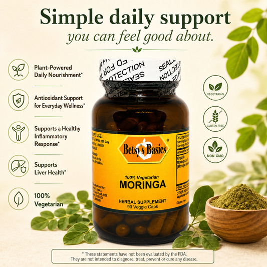 Betsy's Basics Moringa herbal supplement bottle with a yellow label, surrounded by green leaves, a small bowl of green powder, and marketing text on a light beige background.